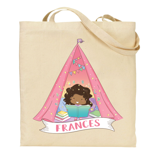 cotton tote bag with a african american girl reading a book inside a pink tent, with 'Frances' text.